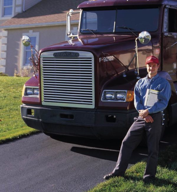 man-posing-by-big-rig-cab-parked-by-house-1999644_rsz